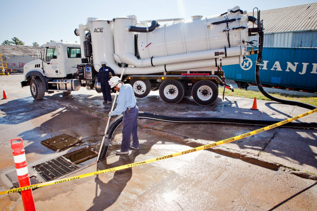 Technician removes plastic spill from drain